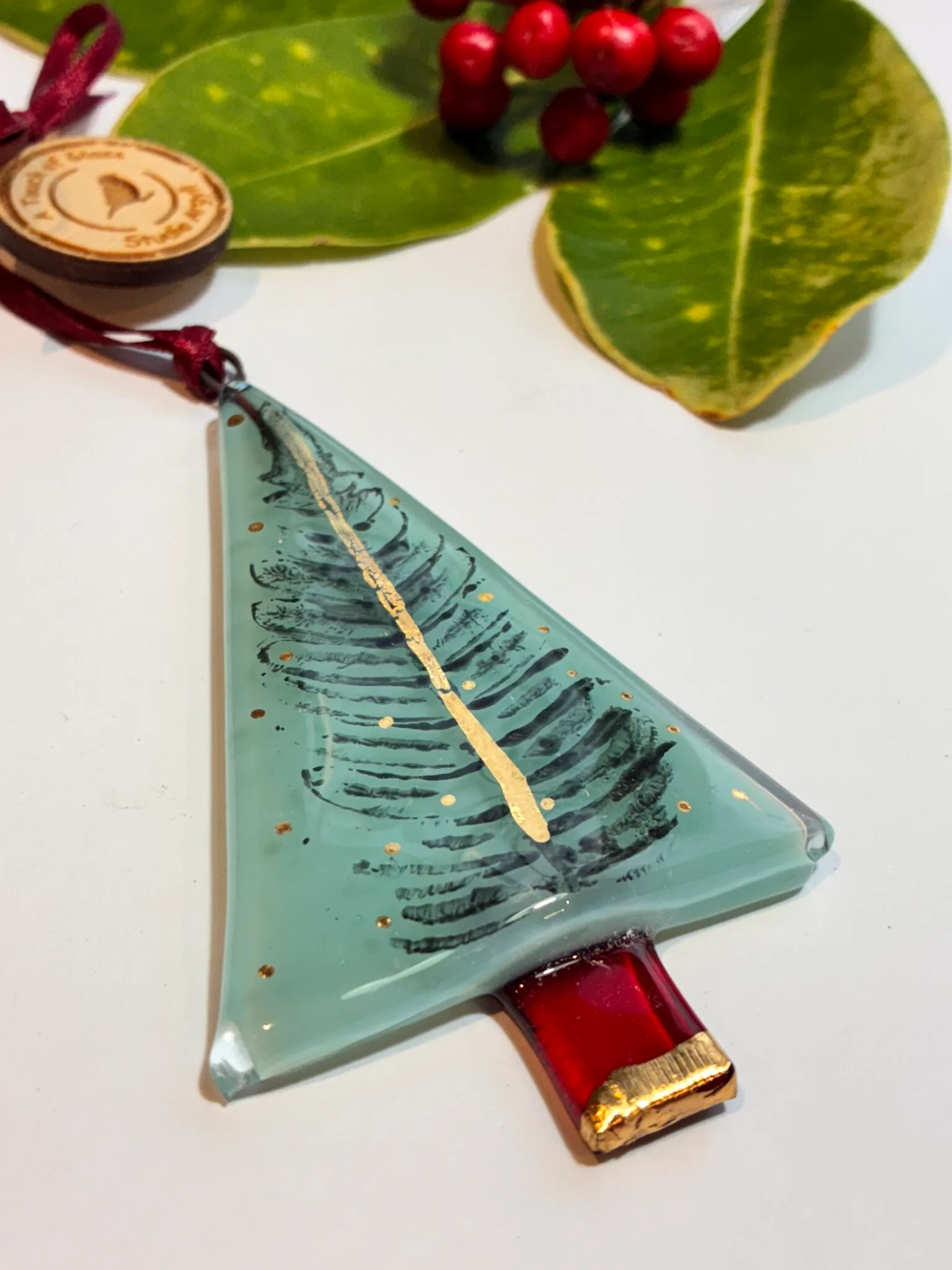Fused glass christmas tree in teal with printed Fern Leaf and gold trunk and decoration.